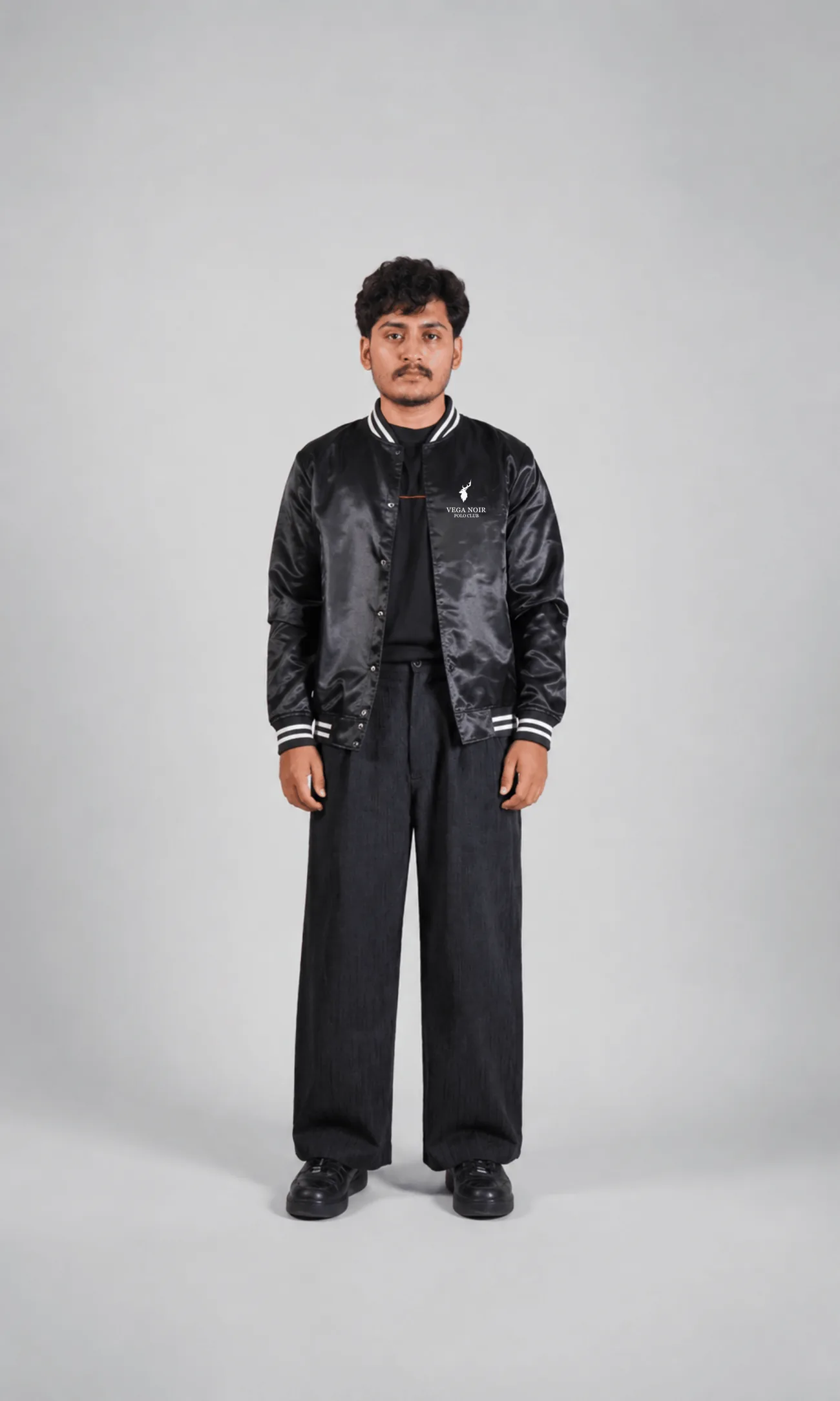 Vega Noir model wearing the Satin varsity bomber jacket